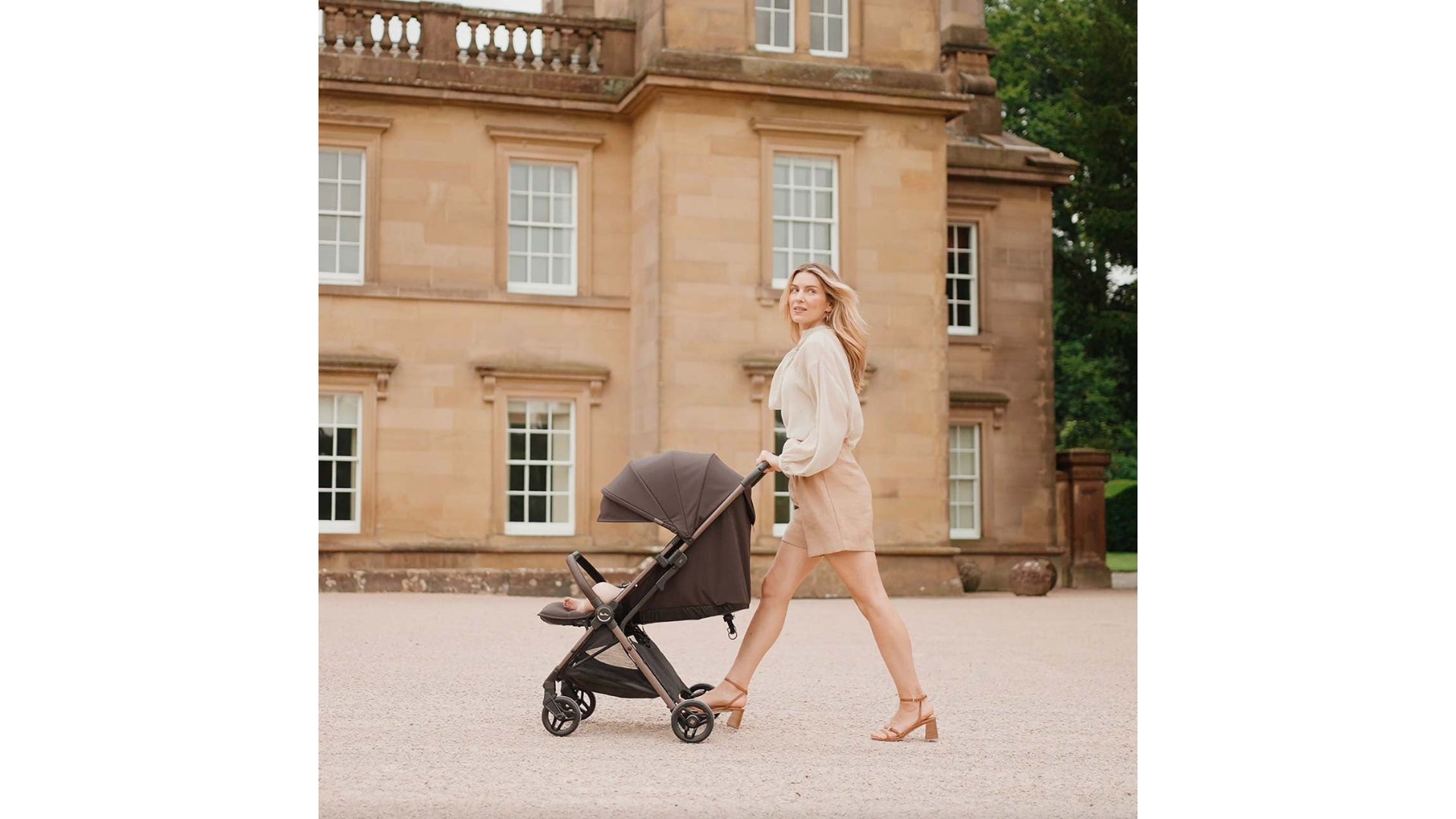 Silver Cross Jet 5 pushed on sidewalk