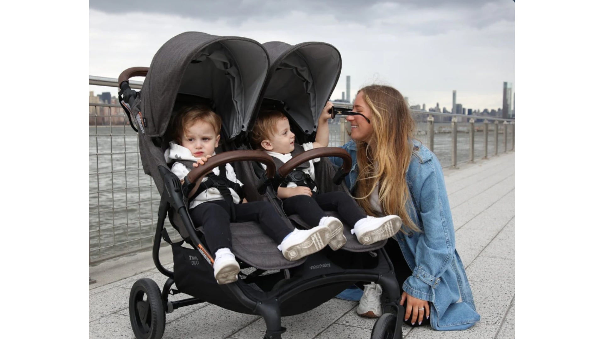 Valco Trend Duo with two seated twin toddlers